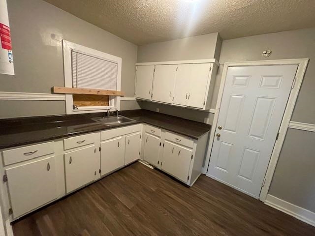 770 Waring Road Memphis, TN 38122 - Photo 10 of 12 a kitchen with wooden floors white cabinets and sink