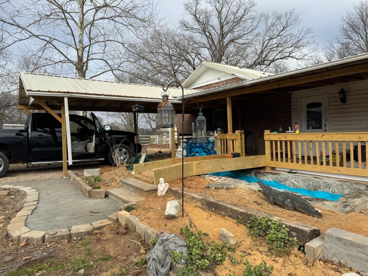 395 Hannis Road Bolivar, TN 38008 - Photo 21 of 24 a view of a house with large windows and wooden fence