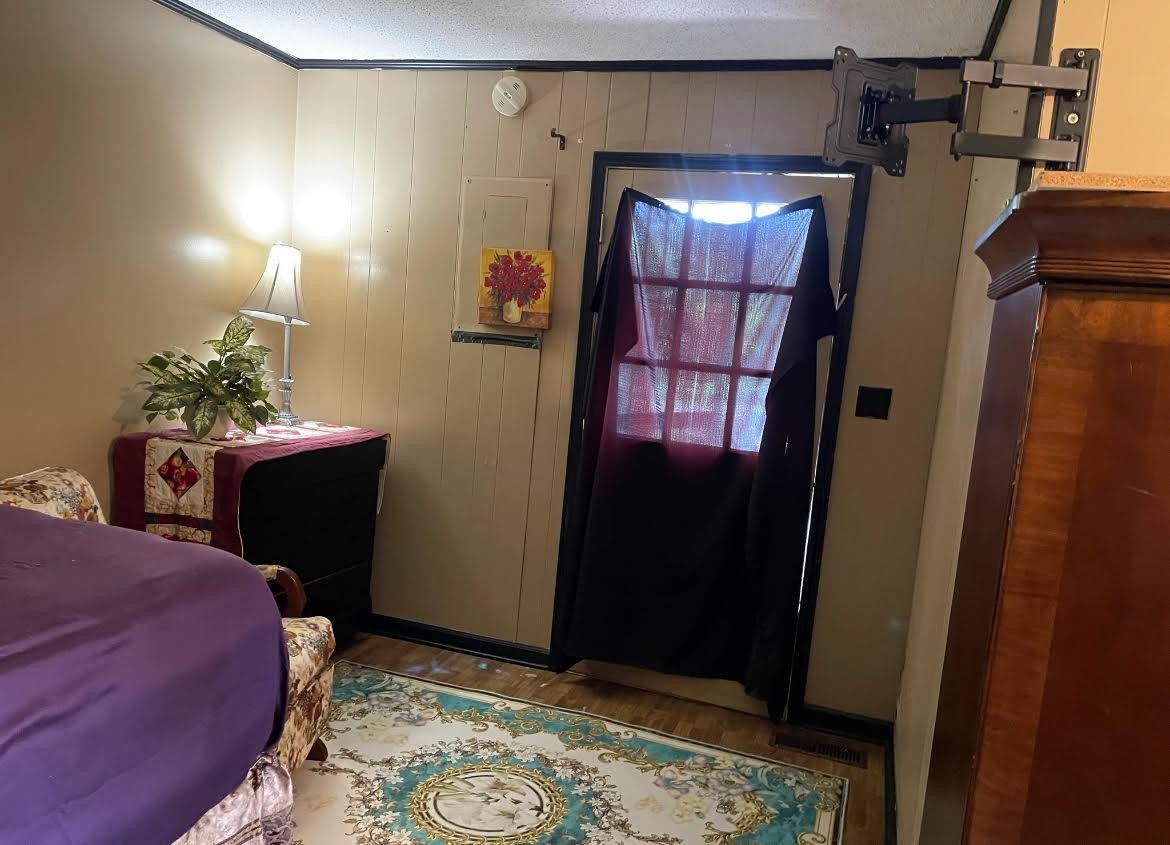 395 Hannis Road Bolivar, TN 38008 - Photo 24 of 24 a bedroom with a bed and a potted plant