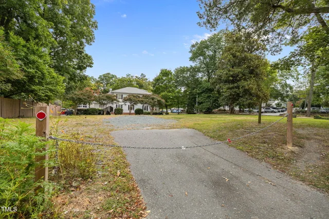 an aerial view of a residential houses with yard
