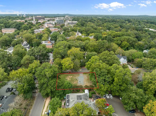 an aerial view of a houses with a yard