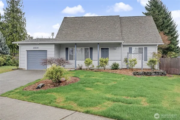 a front view of a house with a garden and patio