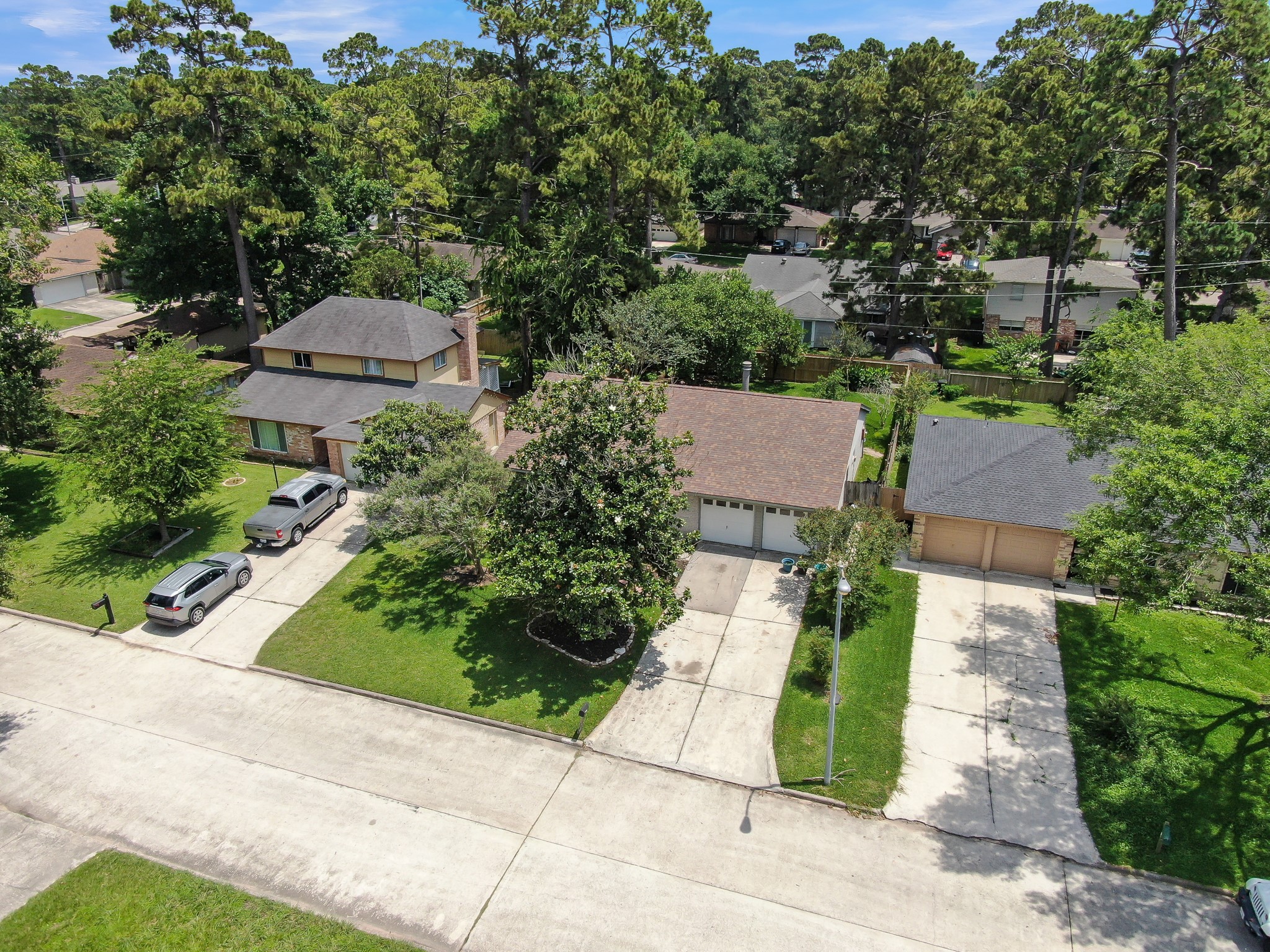 4314 Enchantedgate Drive Spring, TX 77373 - Photo 40 of 47 Charming two-story home with a spacious driveway and well-maintained lawn. Surrounded by mature trees, it offers a peaceful suburban setting with nearby houses. Perfect for those seeking a serene neighborhood.