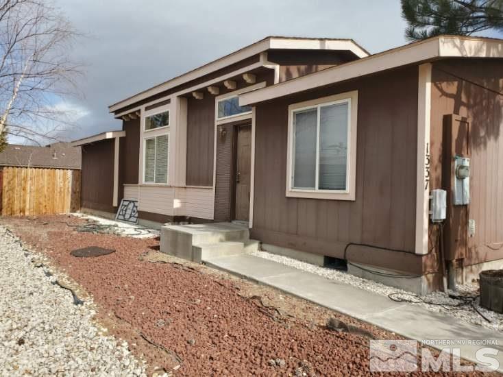 1337 Lynx Street Reno, NV 89506 - Photo 3 of 20 a front view of a house with a yard and garage