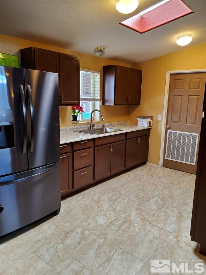 1337 Lynx Street Reno, NV 89506 - Photo 8 of 20 a kitchen with stainless steel appliances a refrigerator and a sink