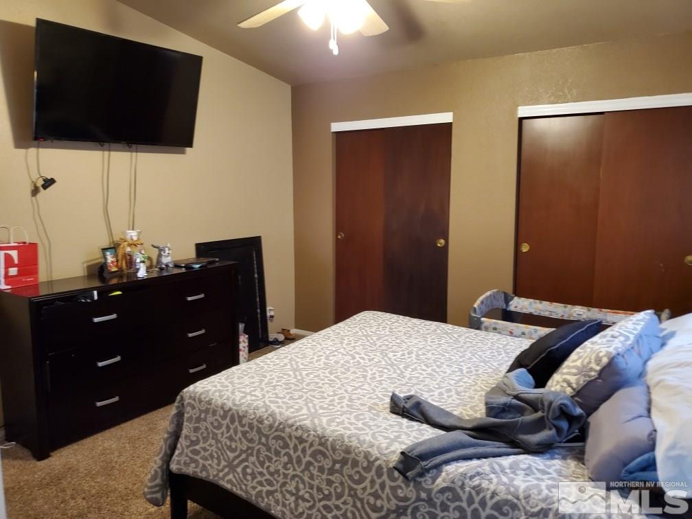 1337 Lynx Street Reno, NV 89506 - Photo 10 of 20 a bedroom with a bed and a flat screen tv