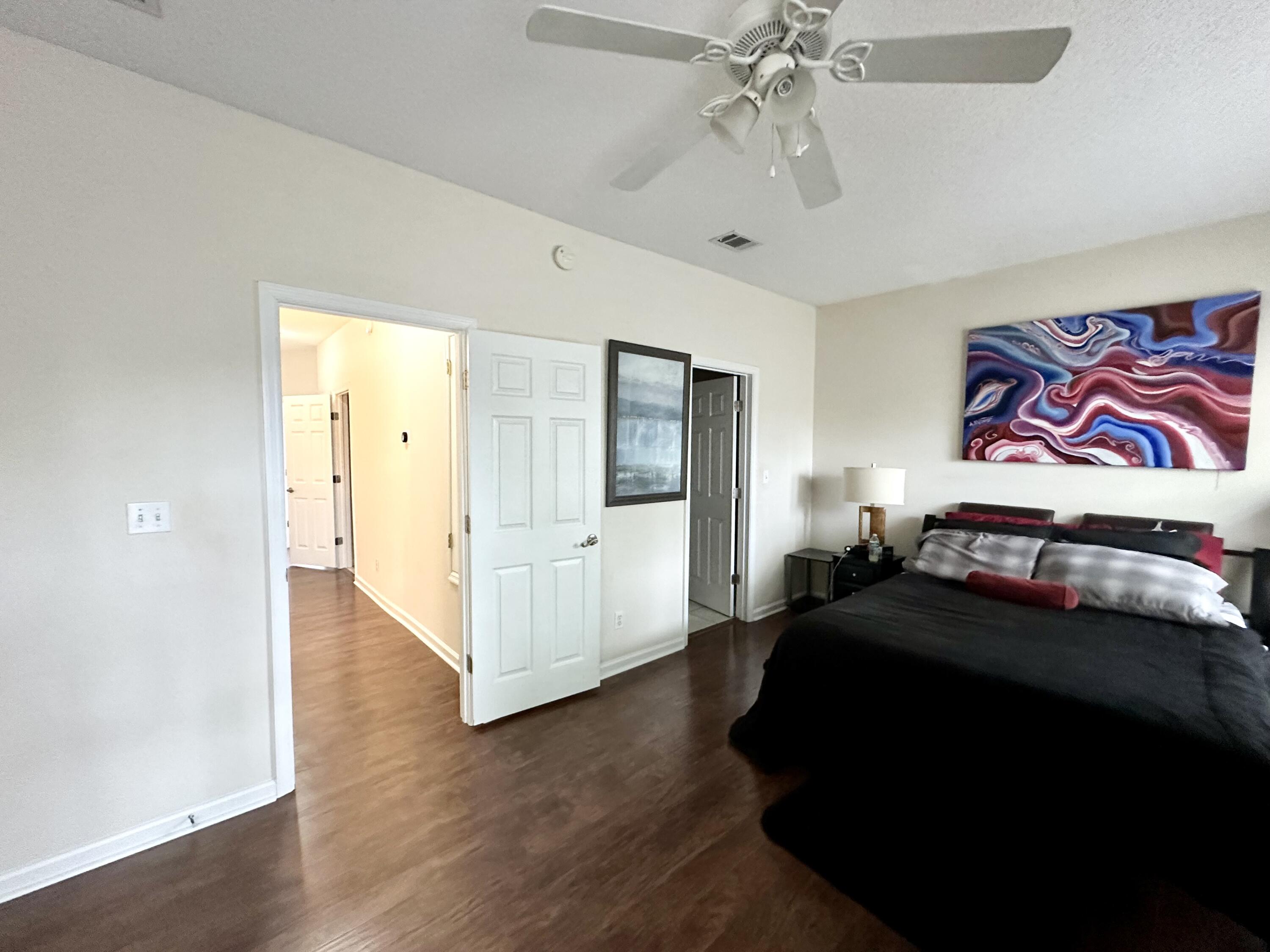 732 East Mack Bayou Drive, Unit 2 Santa Rosa Beach, FL 32459 - Photo 20 of 43 a bedroom with a bed and a chandelier