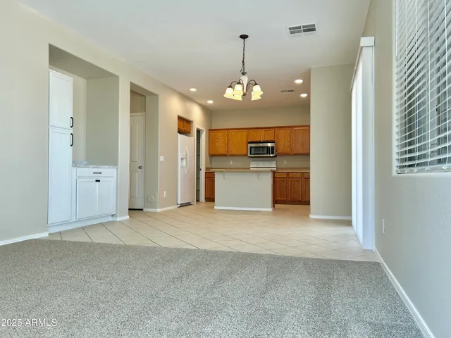 a view of a kitchen with a sink and a refrigerator