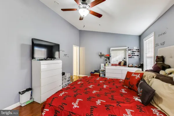 a bedroom with a bed and flat screen tv