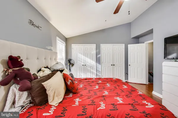 a bedroom with a bed and a tv