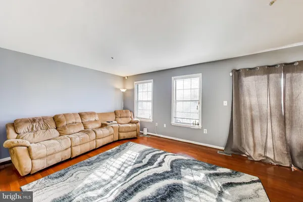 a bedroom with a bed couch and window