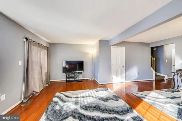 a spacious bedroom with a bed and a flat screen tv