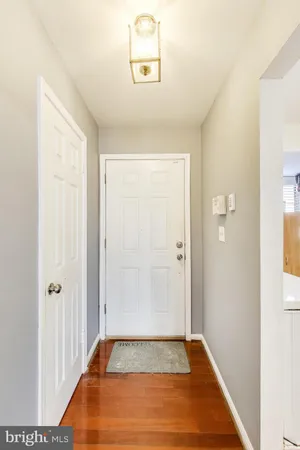 a view of a room with wooden floor