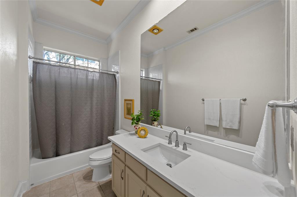 4315 Northaven Road Dallas, TX 75229 - Photo 23 of 40 The beautifully updated Jack-and-Jill bathroom features new quartz countertops, stylish new flooring, updated fixtures, and fresh modern finishes that create a clean and timeless look. The functional shared layout offers both convenience and comfort while maintaining an elegant, updated design throughout the upstairs living spaces.