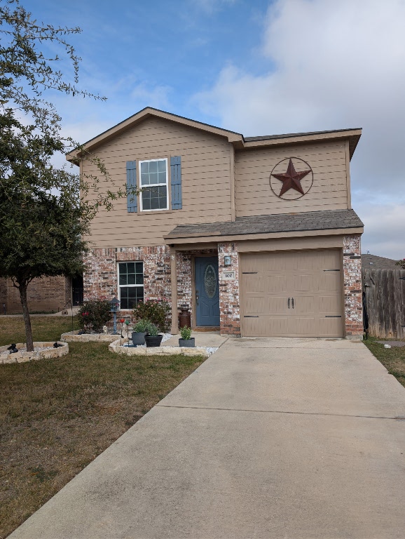 Traditional-style house featuring a front entry attached garage