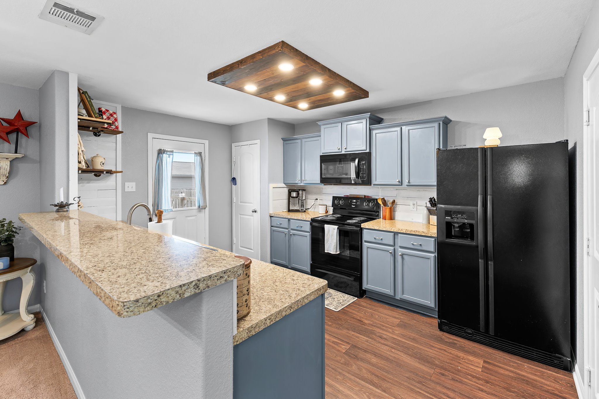 100 Wincliff Cove, Unit 13D Jarrell, TX 76537 - Photo 11 of 40 a kitchen with granite countertop stainless steel appliances a refrigerator and a stove top oven