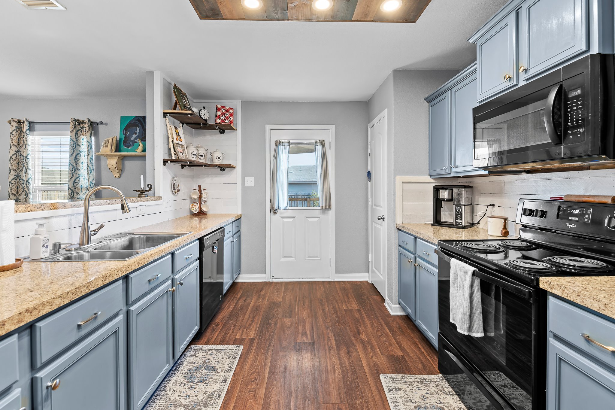100 Wincliff Cove, Unit 13D Jarrell, TX 76537 - Photo 12 of 40 a kitchen with stainless steel appliances granite countertop a stove and a sink