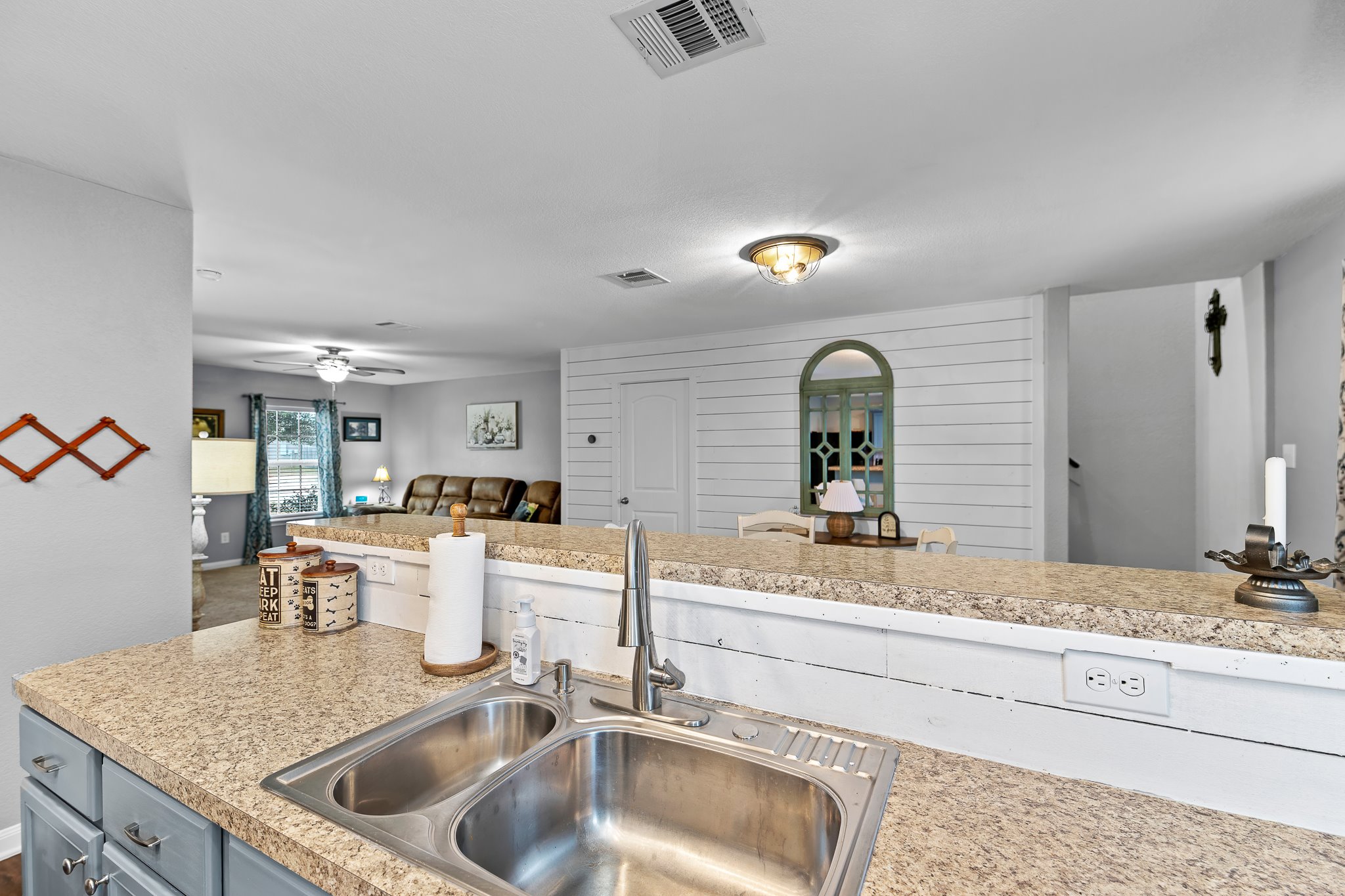 100 Wincliff Cove, Unit 13D Jarrell, TX 76537 - Photo 15 of 40 a kitchen with a sink and a wooden floor