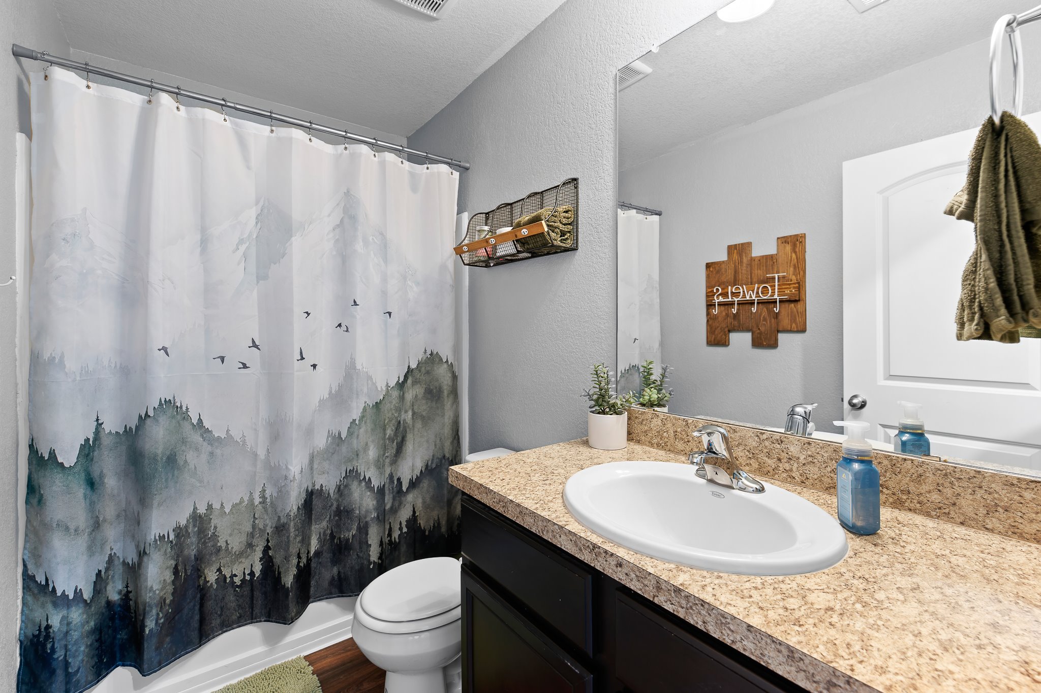 100 Wincliff Cove, Unit 13D Jarrell, TX 76537 - Photo 26 of 40 a bathroom with a granite countertop sink a toilet and a mirror