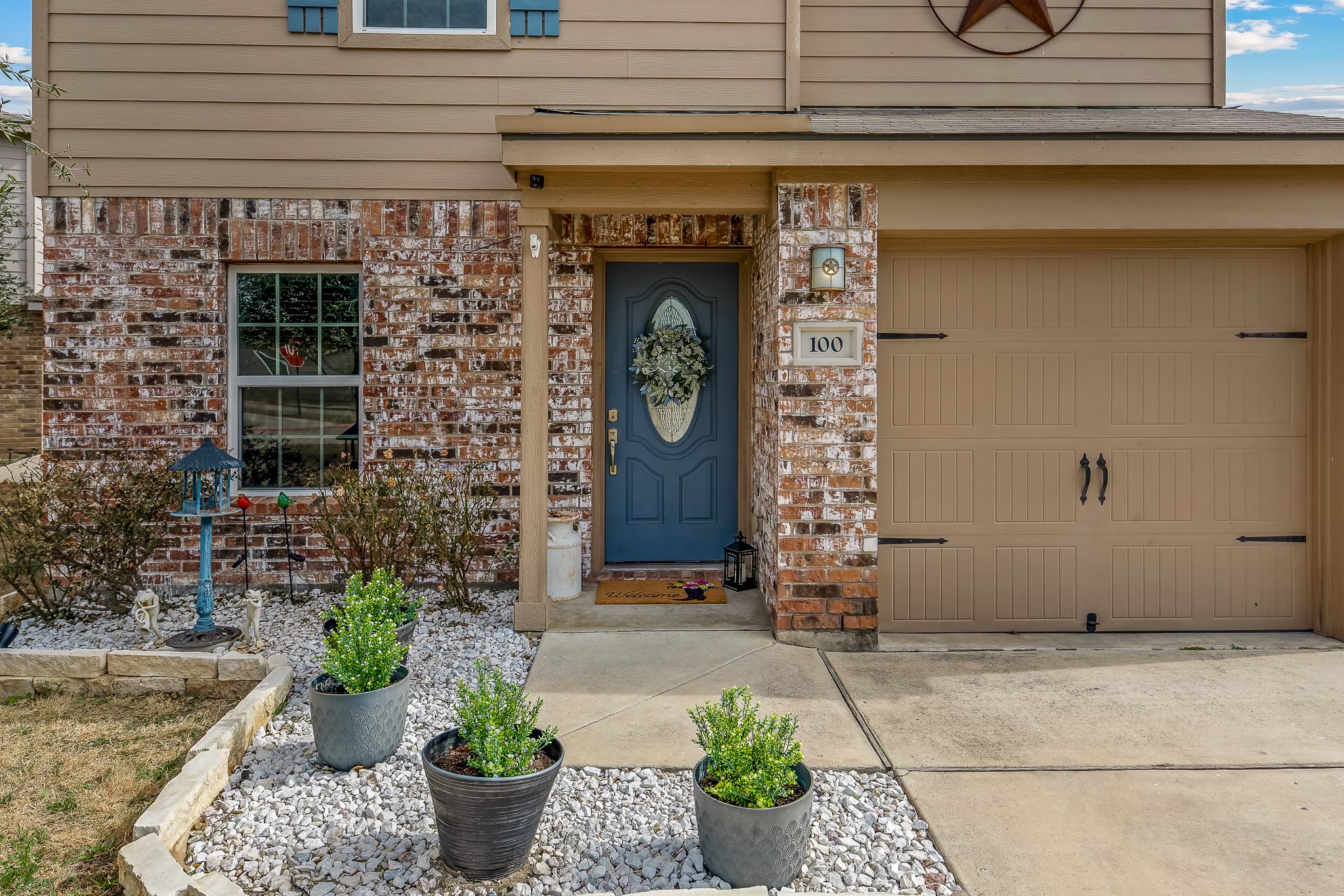 100 Wincliff Cove, Unit 13D Jarrell, TX 76537 - Photo 32 of 40 a front view of a house with potted plants