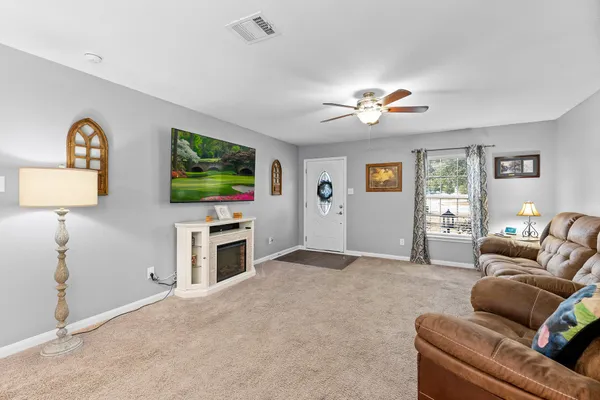 a view of a dining room with furniture and chandelier