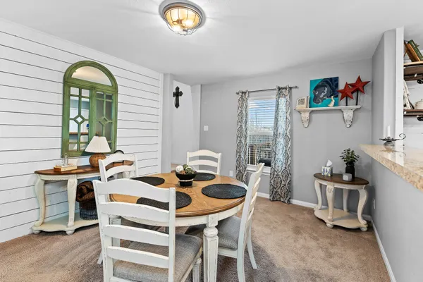 a kitchen with granite countertop stainless steel appliances a refrigerator and a stove top oven