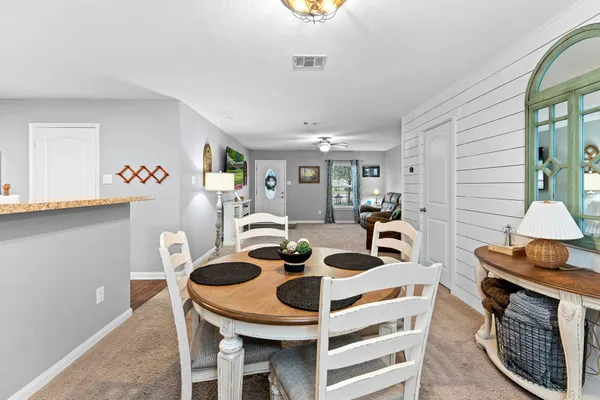 a kitchen with a sink and a wooden floor