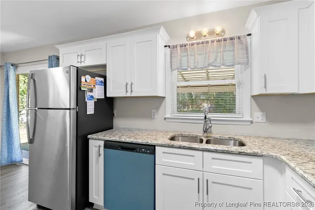 a kitchen with refrigerator and window