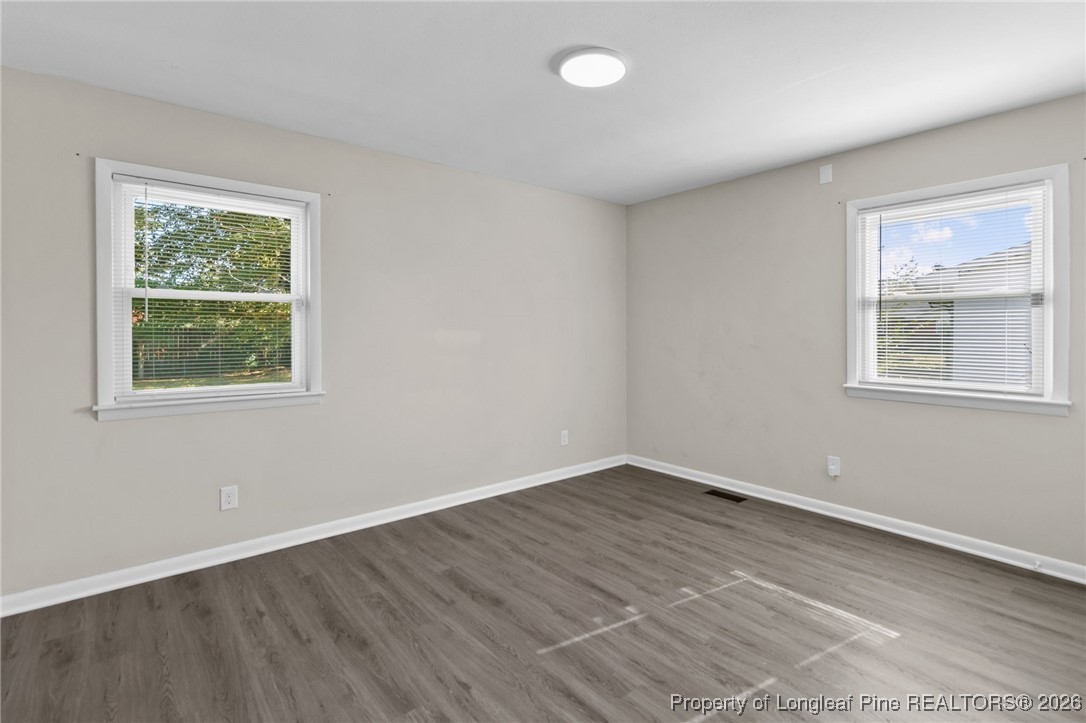 5414 Plateau Road Fayetteville, NC 28303 - Photo 14 of 27 a view of an empty room with wooden floor and a window