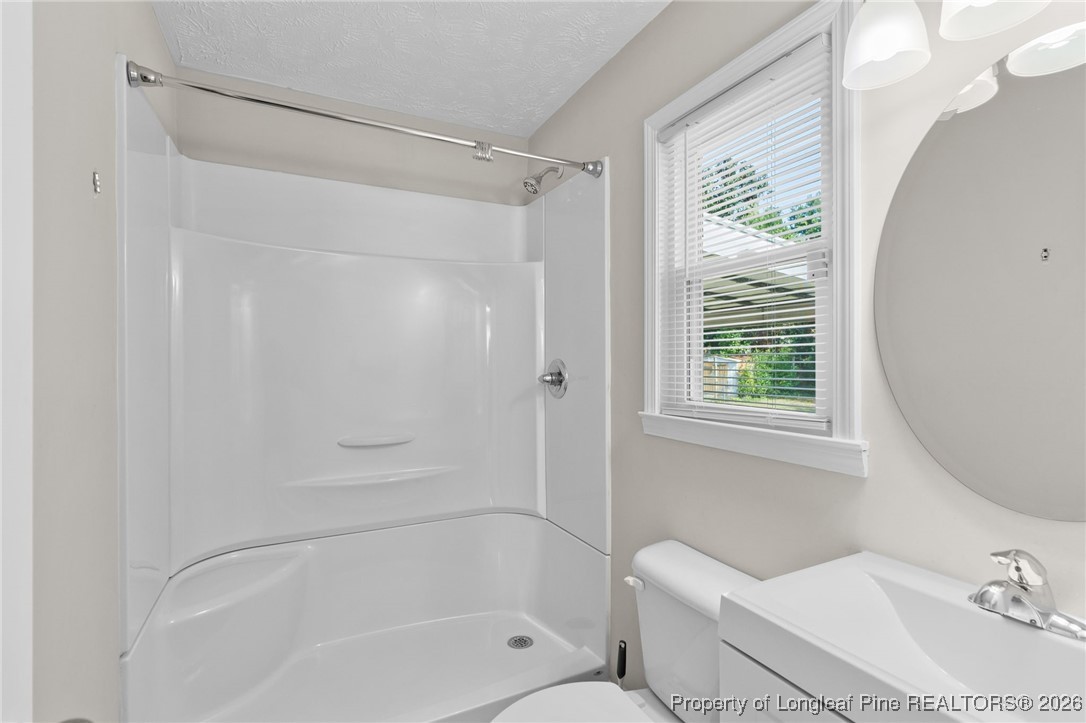 5414 Plateau Road Fayetteville, NC 28303 - Photo 16 of 27 a bathroom with a sink toilet and shower