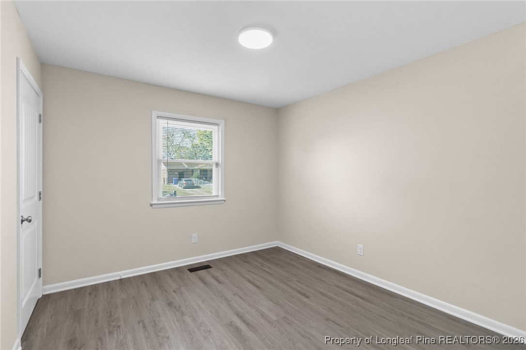 5414 Plateau Road Fayetteville, NC 28303 - Photo 18 of 27 wooden floor in an empty room with a window