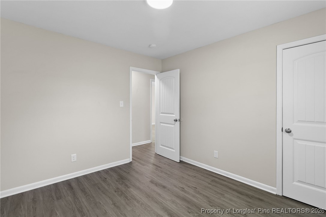 5414 Plateau Road Fayetteville, NC 28303 - Photo 19 of 27 a view of an empty room with wooden floor