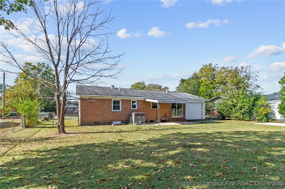 5414 Plateau Road Fayetteville, NC 28303 - Photo 25 of 27 a front view of house with yard and trees in the background