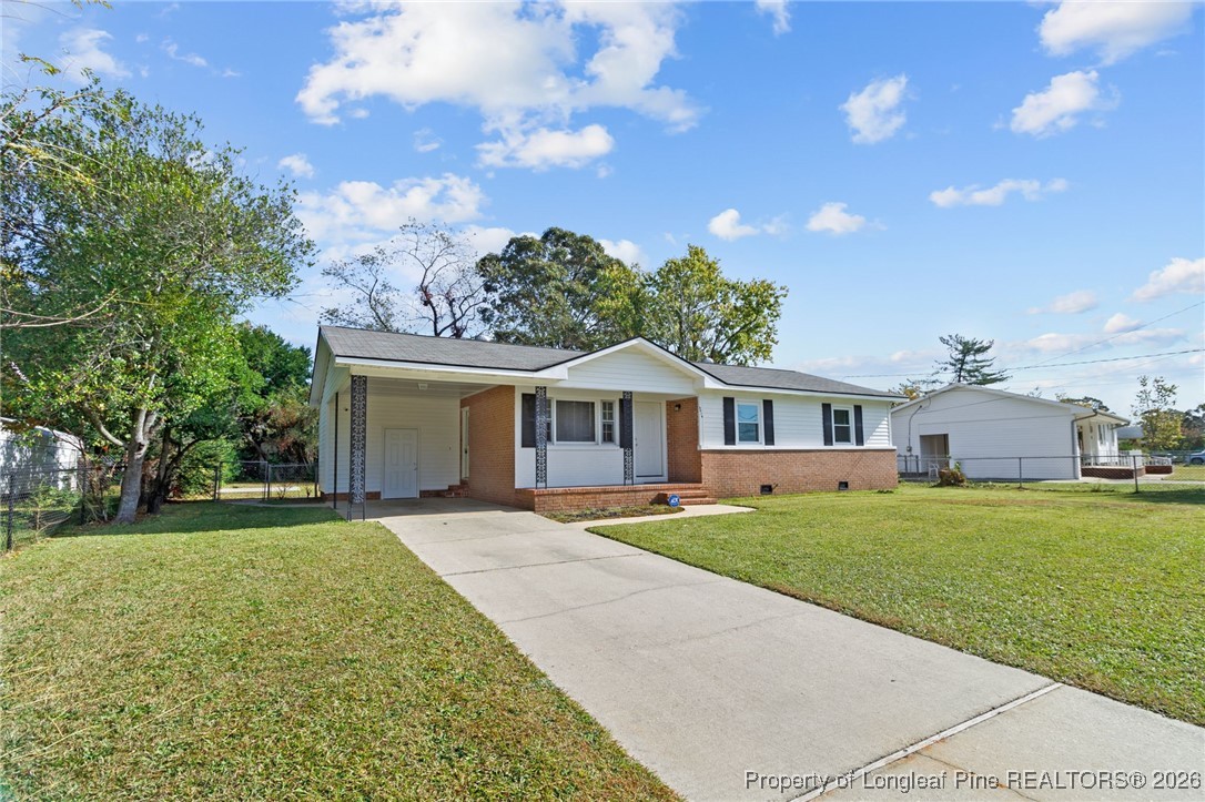 5414 Plateau Road Fayetteville, NC 28303 - Photo 3 of 27 a front view of a house with a garden and trees