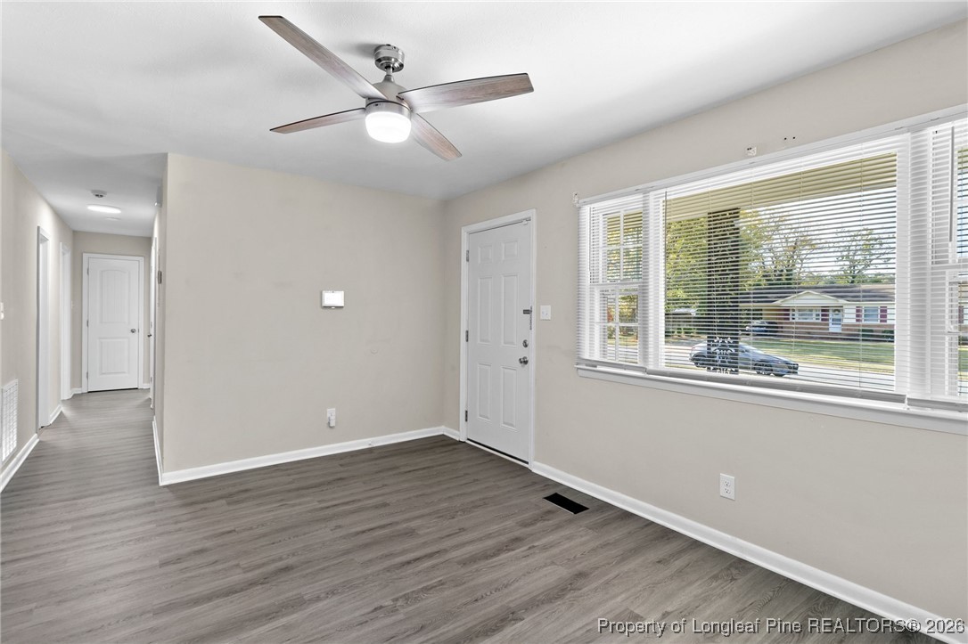 5414 Plateau Road Fayetteville, NC 28303 - Photo 7 of 27 an empty room with wooden floor and windows