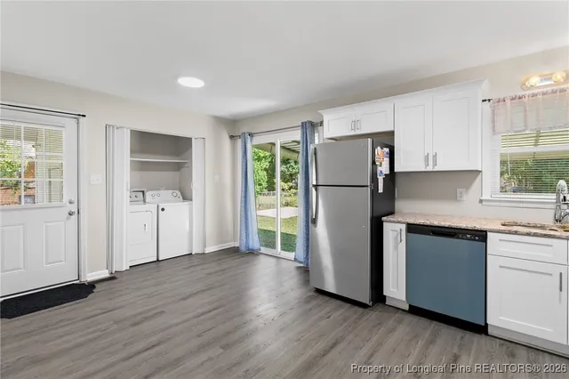 a kitchen with a refrigerator and a sink