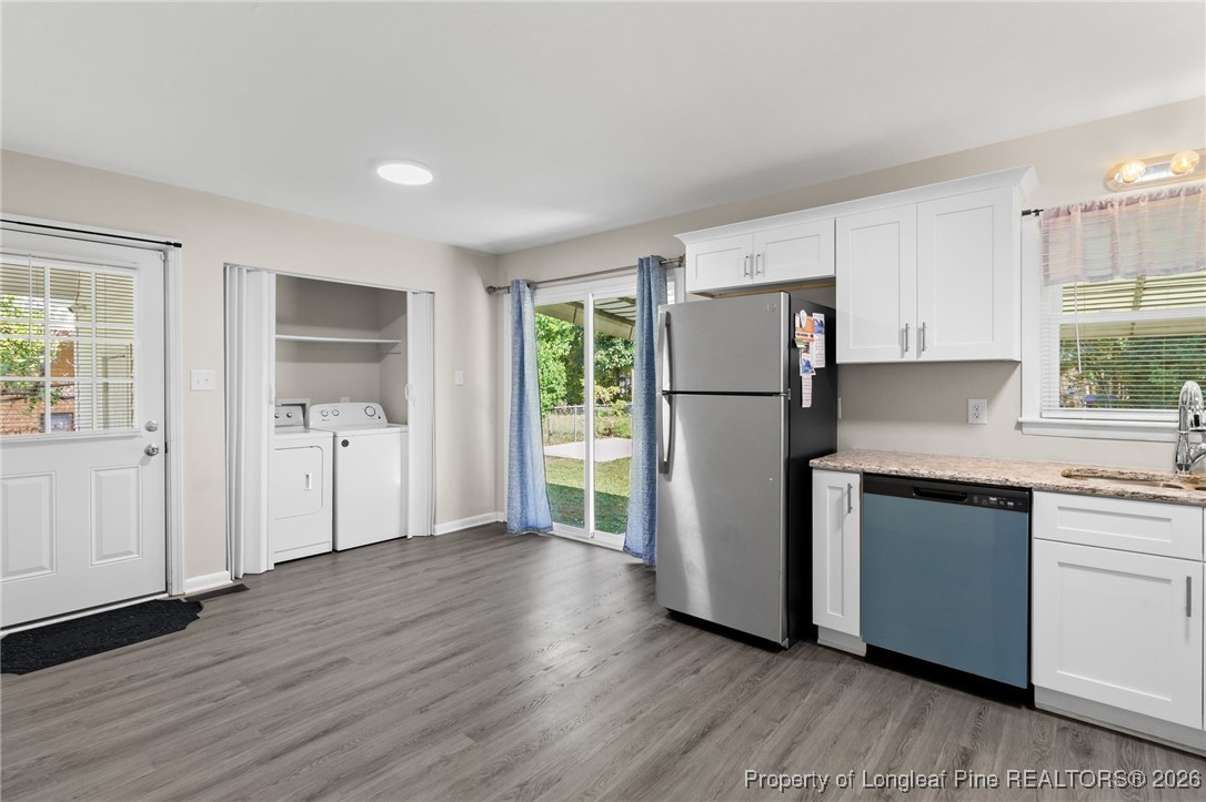 5414 Plateau Road Fayetteville, NC 28303 - Photo 8 of 27 a kitchen with a refrigerator and a sink