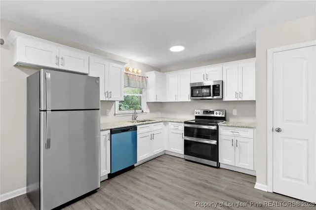 a kitchen with a refrigerator stove and microwave