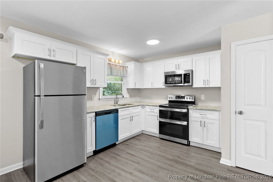 5414 Plateau Road Fayetteville, NC 28303 - Photo 9 of 27 a kitchen with a refrigerator stove and microwave