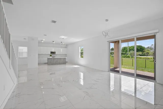 a kitchen with stainless steel appliances a refrigerator sink and microwave