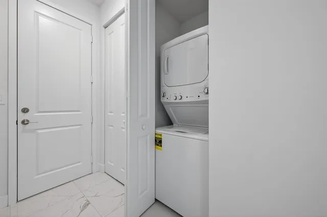 a view of entryway with stairs and white walls