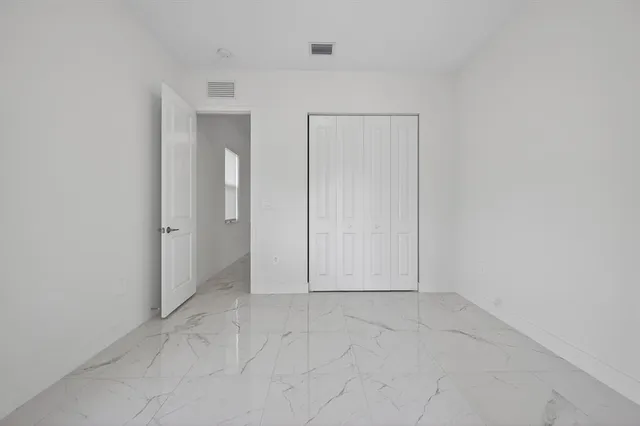 a bedroom with bed and a couch