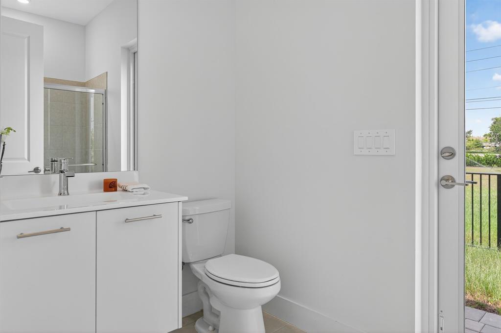 4421 Southwest 123rd Avenue Davie, FL 33330 - Photo 28 of 62 a bathroom with a toilet sink and mirror