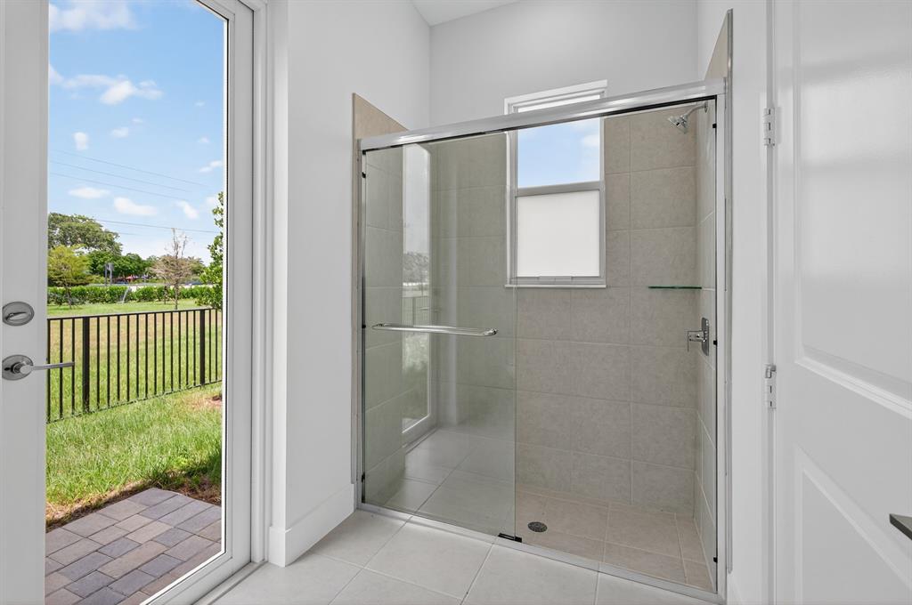 4421 Southwest 123rd Avenue Davie, FL 33330 - Photo 29 of 62 a bathroom with a glass shower door