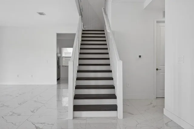 a bathroom with a shower sink and mirror