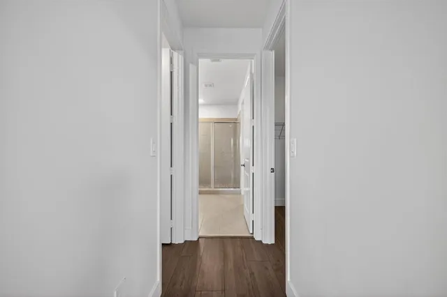 a bathroom with a double vanity sink and mirror with bathtub