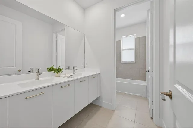 a front view of a house with a garden and garage