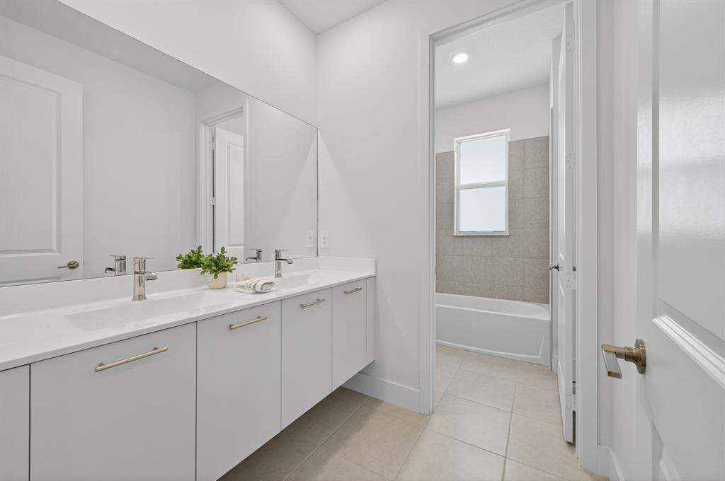 4421 Southwest 123rd Avenue Davie, FL 33330 - Photo 45 of 62 a bathroom with a double vanity sink and mirror with bathtub
