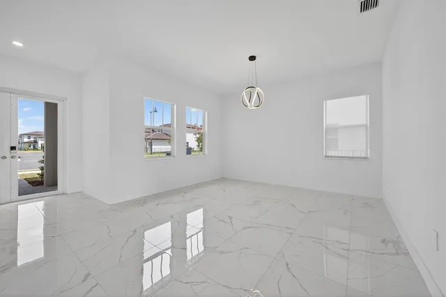 a kitchen with a sink a refrigerator and cabinets