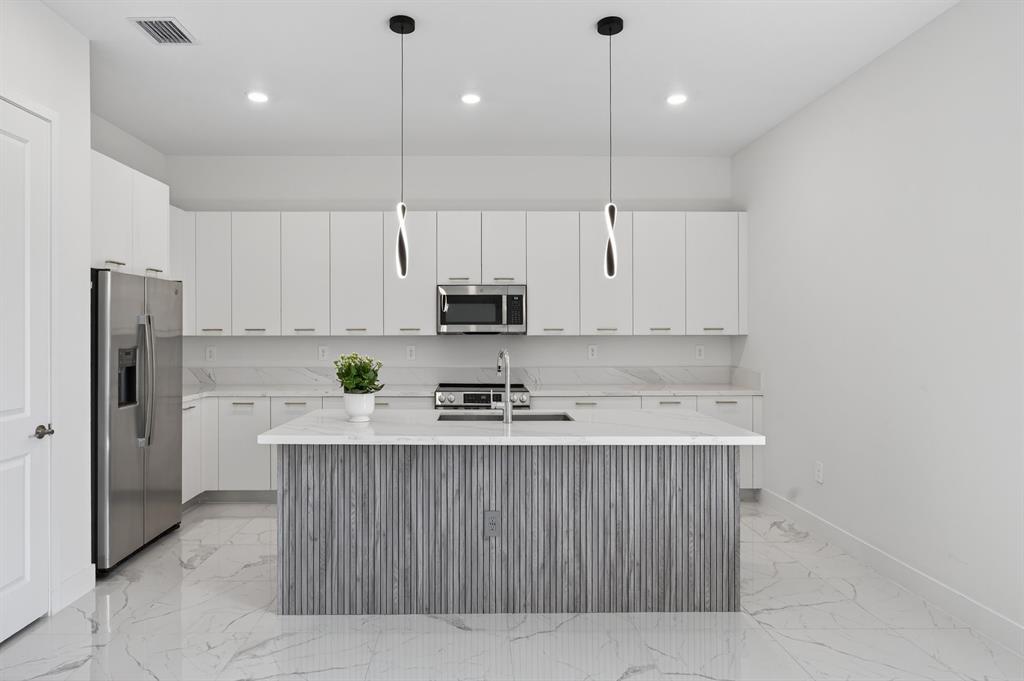 4421 Southwest 123rd Avenue Davie, FL 33330 - Photo 9 of 62 a kitchen with stainless steel appliances granite countertop a sink a stove a refrigerator and white cabinets